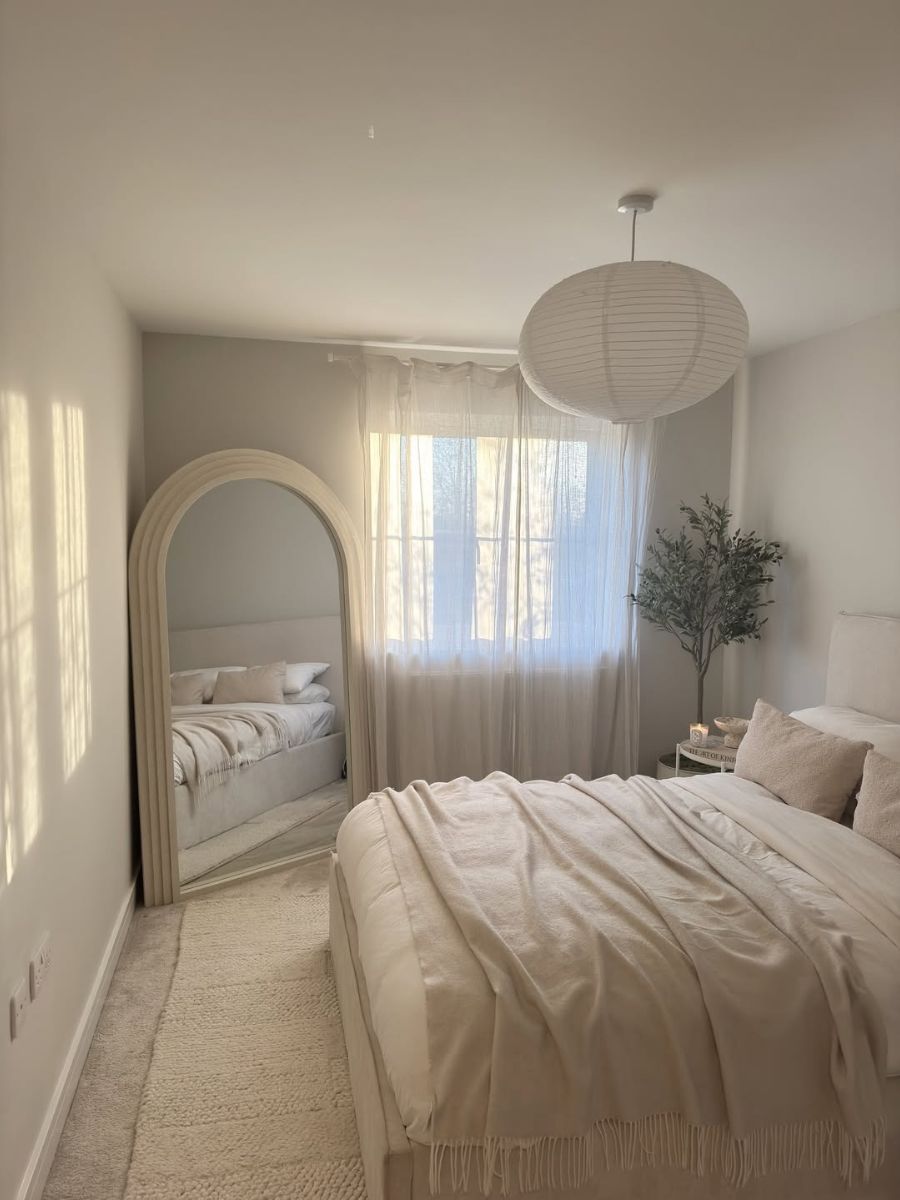 Minimalist bedroom with sheer curtains filtering soft light